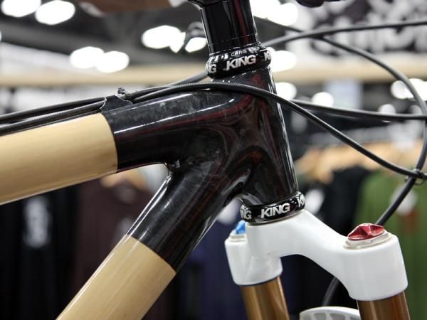 Boo Cycles uses tightly wound rubber straps to compress the hand wrapped carbon fiber joints during the curing process, then sands everything smooth.