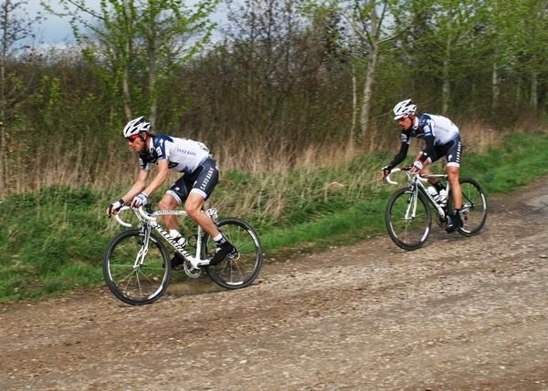 Frank H&oslash;j, Team Saxo Bank leading a teammate into the fifth gravel road
