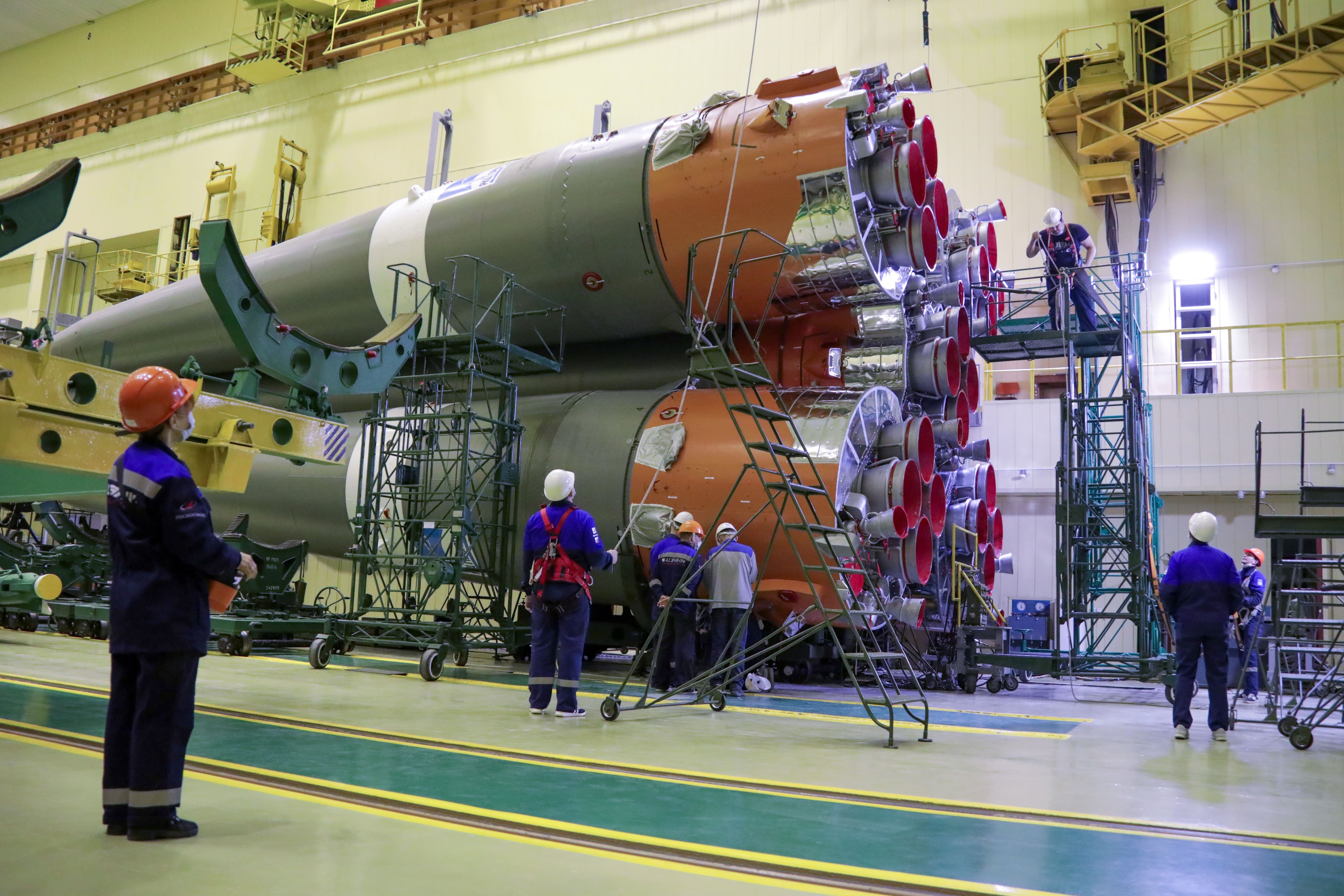 Technicians work on a Russian Soyuz rocket at Baikonur Cosmodrome in Kazakhstan. This Soyuz is scheduled to launch 36 internet satellites for the company OneWeb on March 4, 2022.