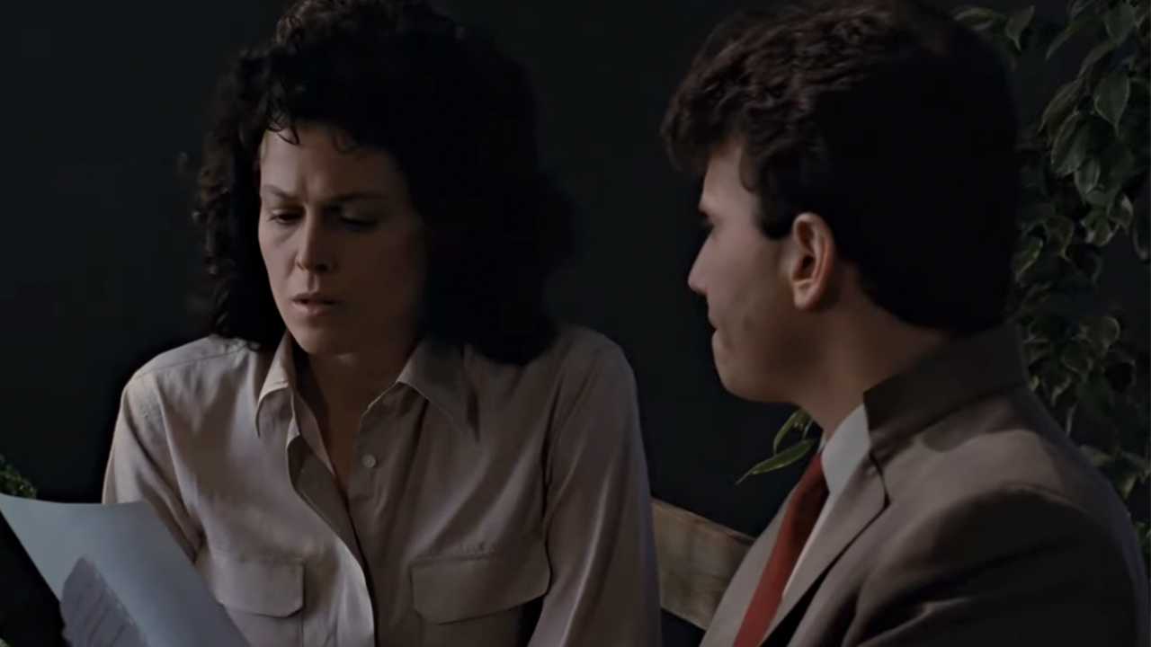 Sigourney Weaver and Paul Reiser looking at a piece of paper in Aliens.