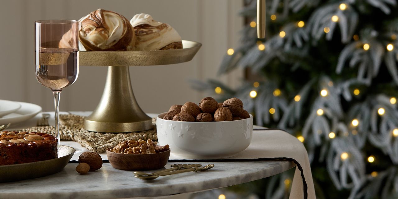 A Christmas table scape with metallic accents and wooden details