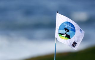 A flag with AT&T Pebble Beach Pro-Am flies in the wind