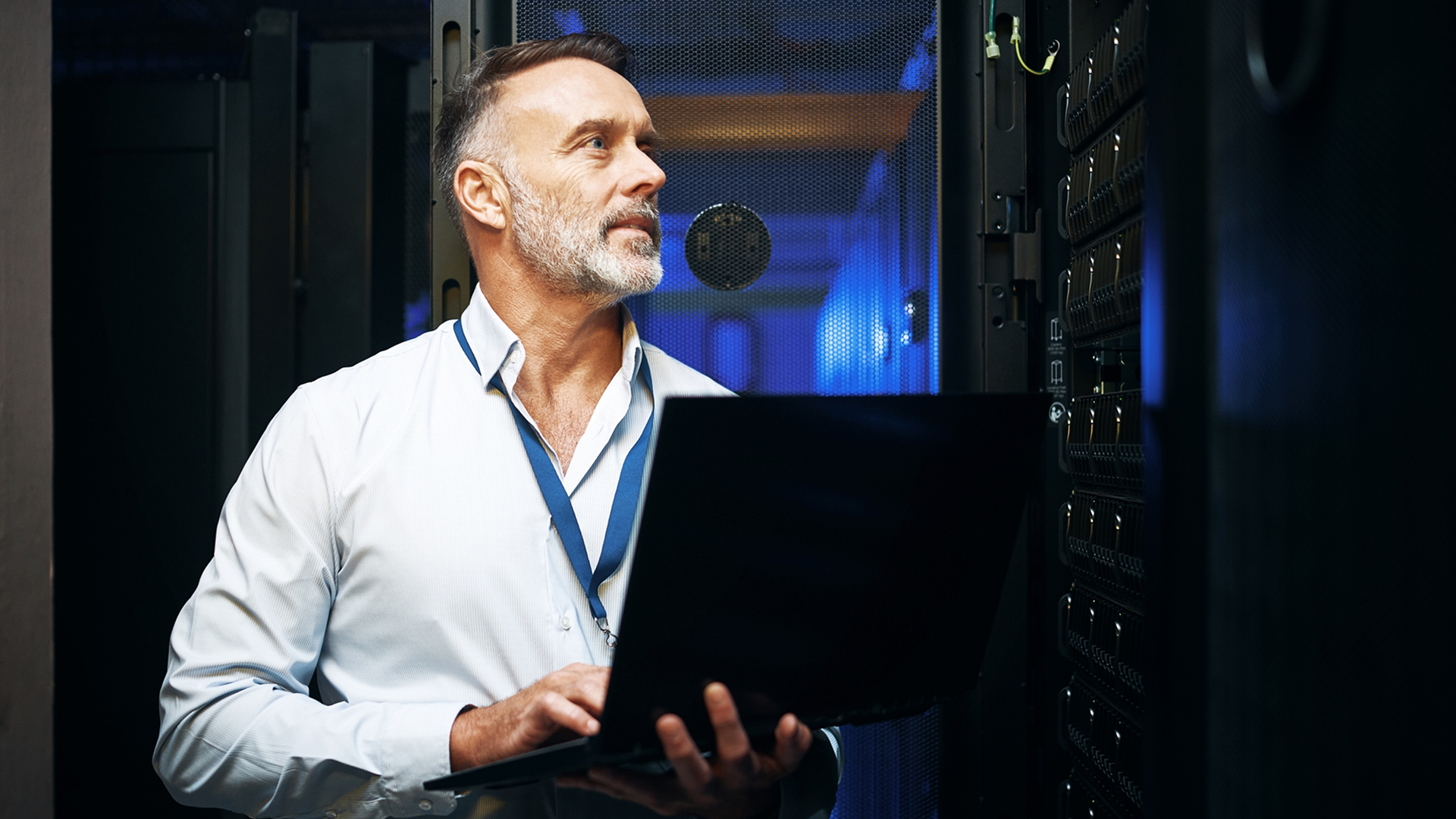 A person in a data center using a laptop