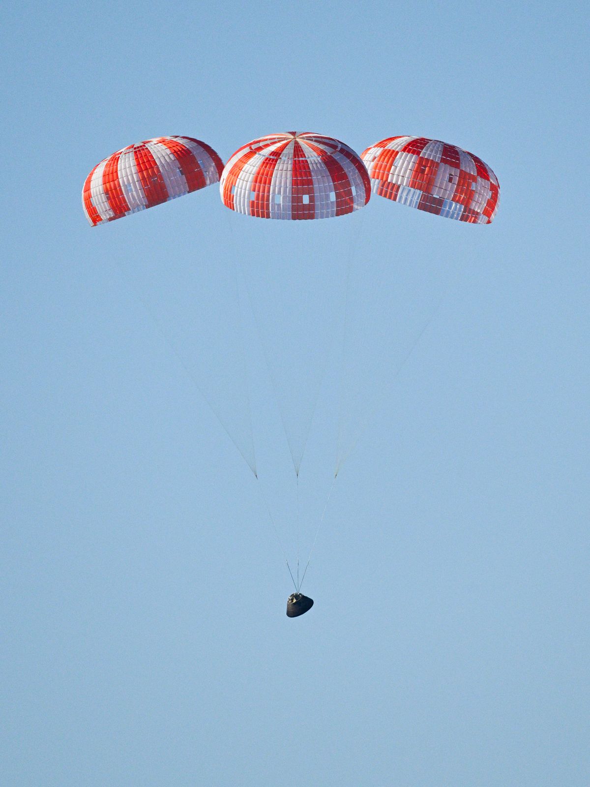 Parachutes secured to NASA&rsquo;s Orion spacecraft deploy before splashdown in the Pacific Ocean near San Diego, California, on Friday, April 10, 2026, for the Artemis II test flight. The Artemis II mission carrying Artemis II Commander Reid Wiseman, Pilot Victor Glover, and Mission Specialist Christina Koch from NASA, along with Mission Specialist Jeremy Hansen from the CSA (Canadian Space Agency), launched on Wednesday, April 1, from NASA&rsquo;s Kennedy Space Center in Florida to begin its 10-day journey around the Moon for scientific discovery, economic benefits, and to build on our foundation for the first crewed missions to Mars. NASA&rsquo;s Landing and Recovery team and the U.S. military are coordinating efforts to extract the Artemis II crew from Orion.
