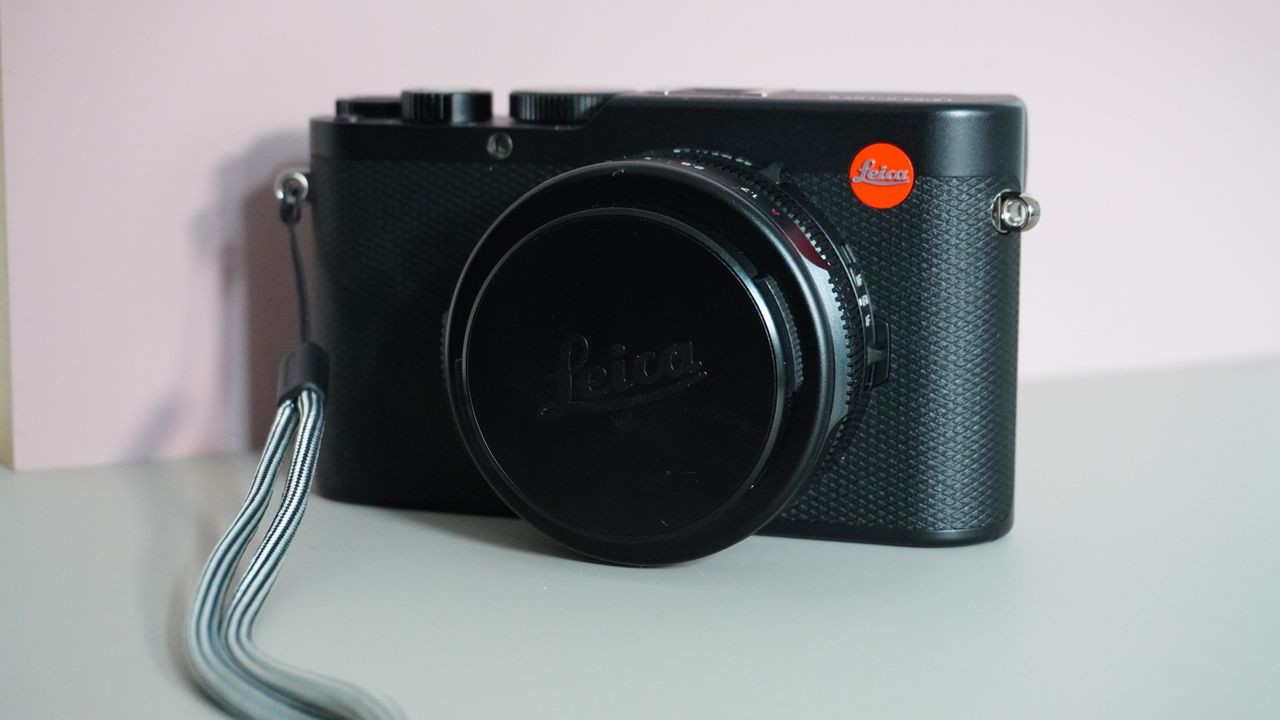 The Leica D-Lux 8 on a grey and pink background