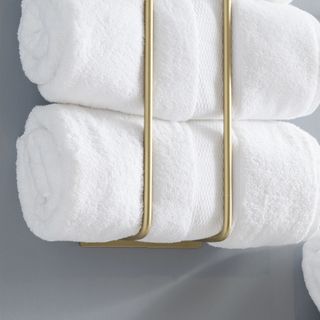 A vertical gold towel rack