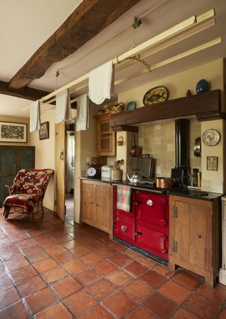 small country style kitchen with red aga in cottage home