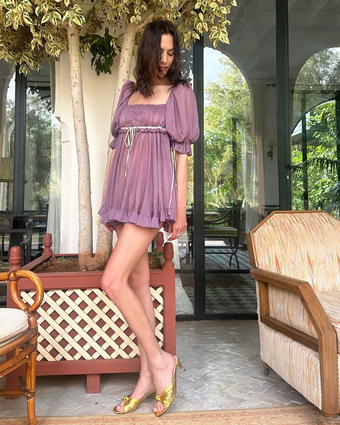 Alexa Chung wears a Chloe SS25 purple minidress with puff sleeve and gold heeled mules in Marrakesh.