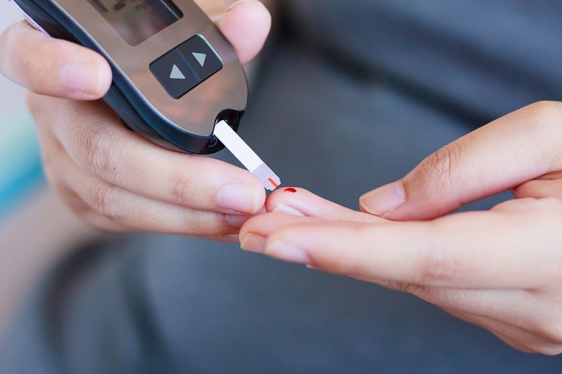 A person checking their blood glucose.