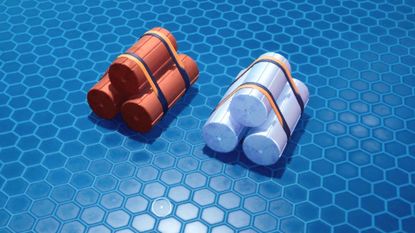 Two Subnautica 2 ingots lie on the floor.