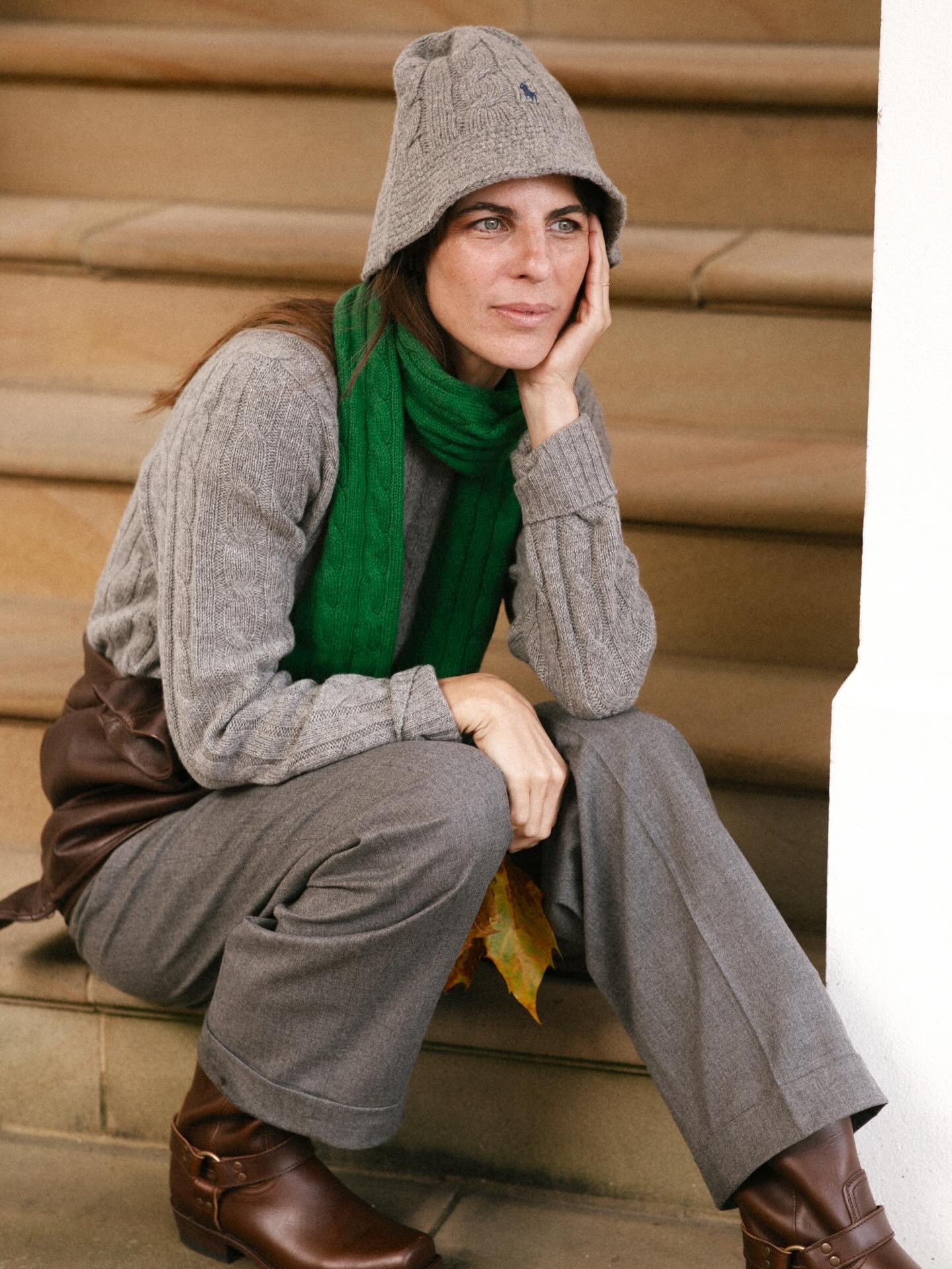 Woman in preppy cable knit sweater.