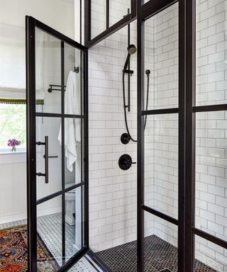 shower room with black steel framed shower and white subway tiles