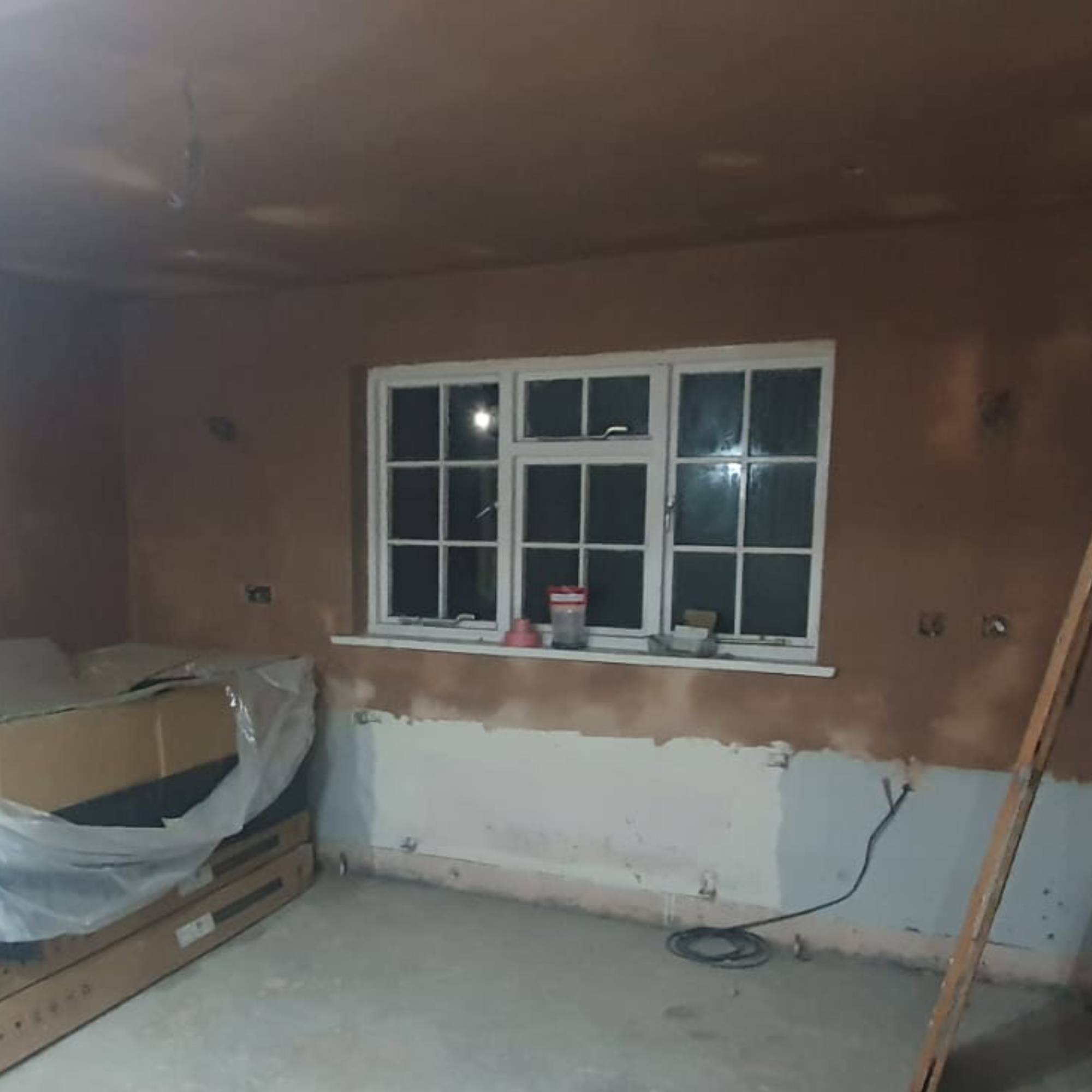 freshly plastered room with white wood windows