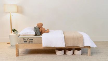 Kid&#039;s mattress on the Avocado Kids&#039; Bed Frame against a white wall.