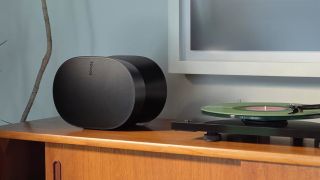 Best turntable speakers: A single Sonos Era 300 speaker atop a cabinet beside a record player