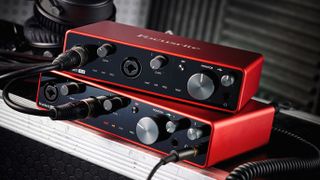 Two Focusrite Scarlett audio interfaces on top of one another, on top of a road case
