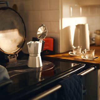 A kitchen stove with a cafetiere on top