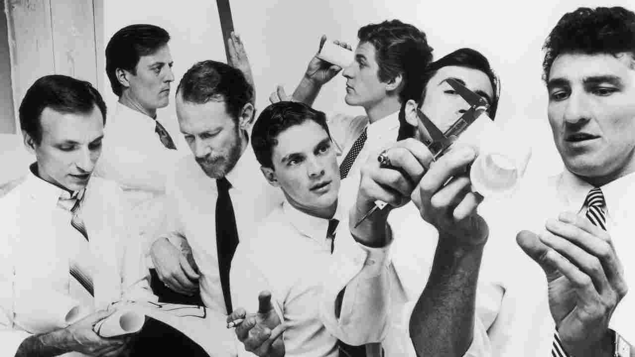 The Tubes posing for a photograph in shirts and ties in 1981