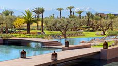 The Fairmont Royal Palm Marrakech with pool and mountains in the distance 