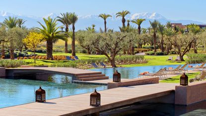 The Fairmont Royal Palm Marrakech with pool and mountains in the distance 