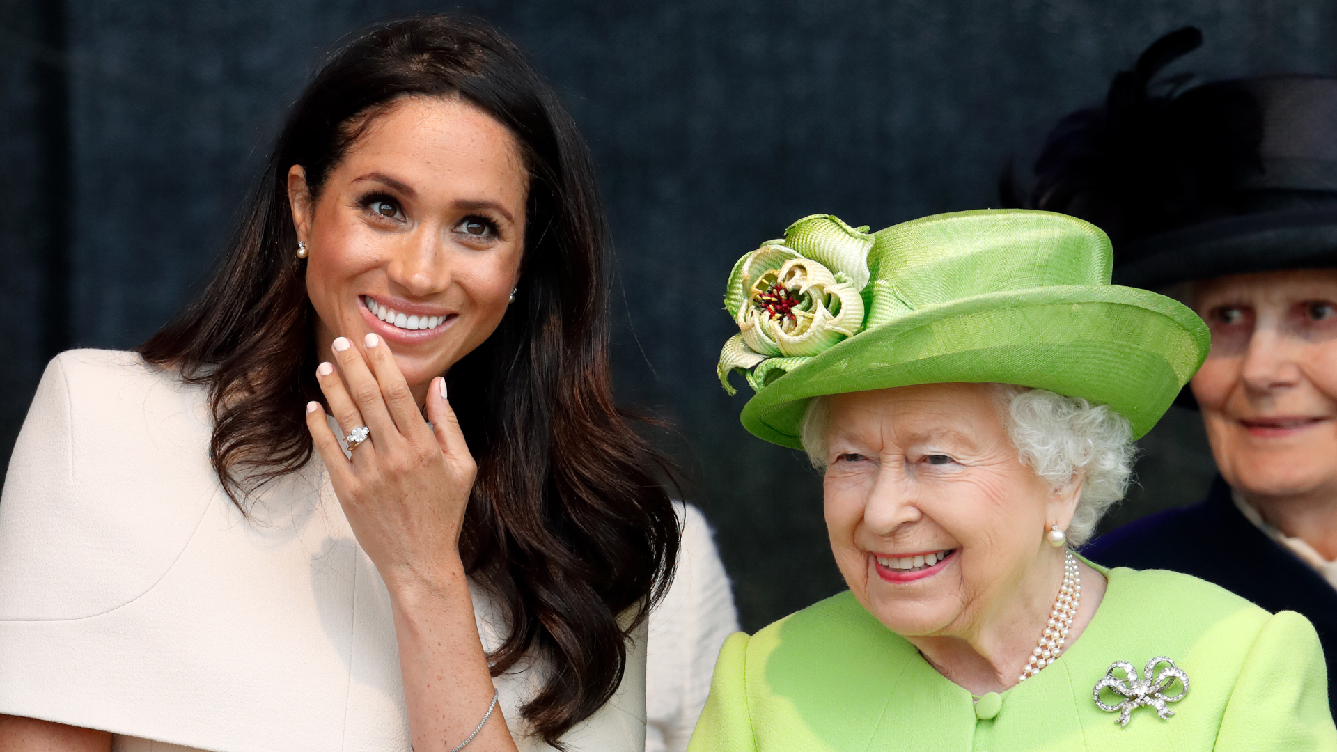 Meghan Markle wears a cream dress and attends a joint engagement with Queen Elizabeth, who wears a bright green coat, on June 14, 2018