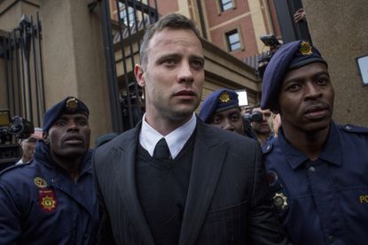 Oscar Pistorius leaves the court