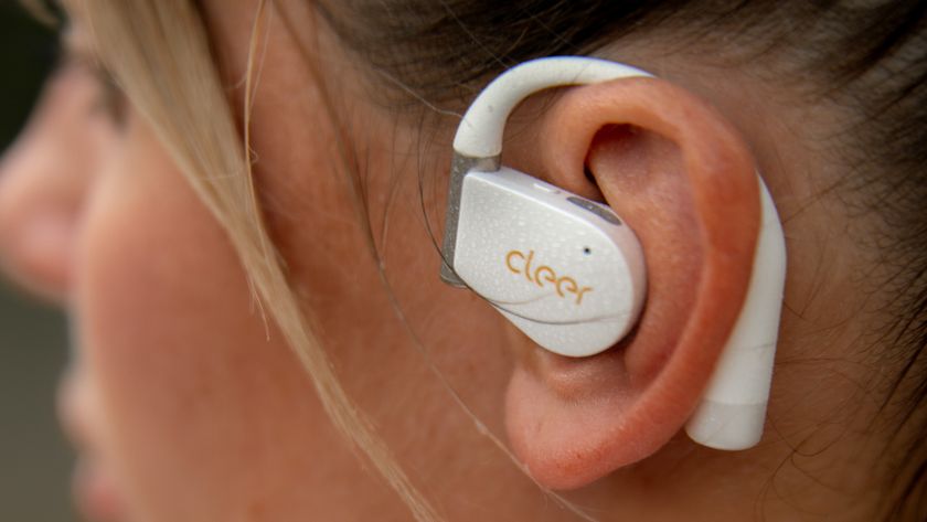 Cleer Audio Arc 4+ wireless earbuds in white being worn