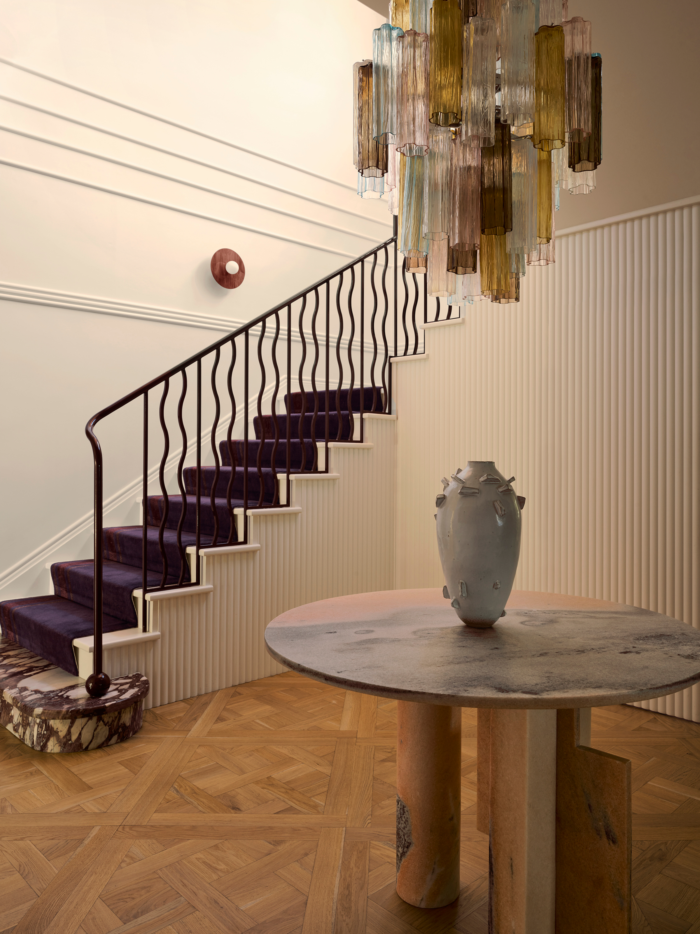 Hallway with fluted panelling, purple stair runner and stone first step