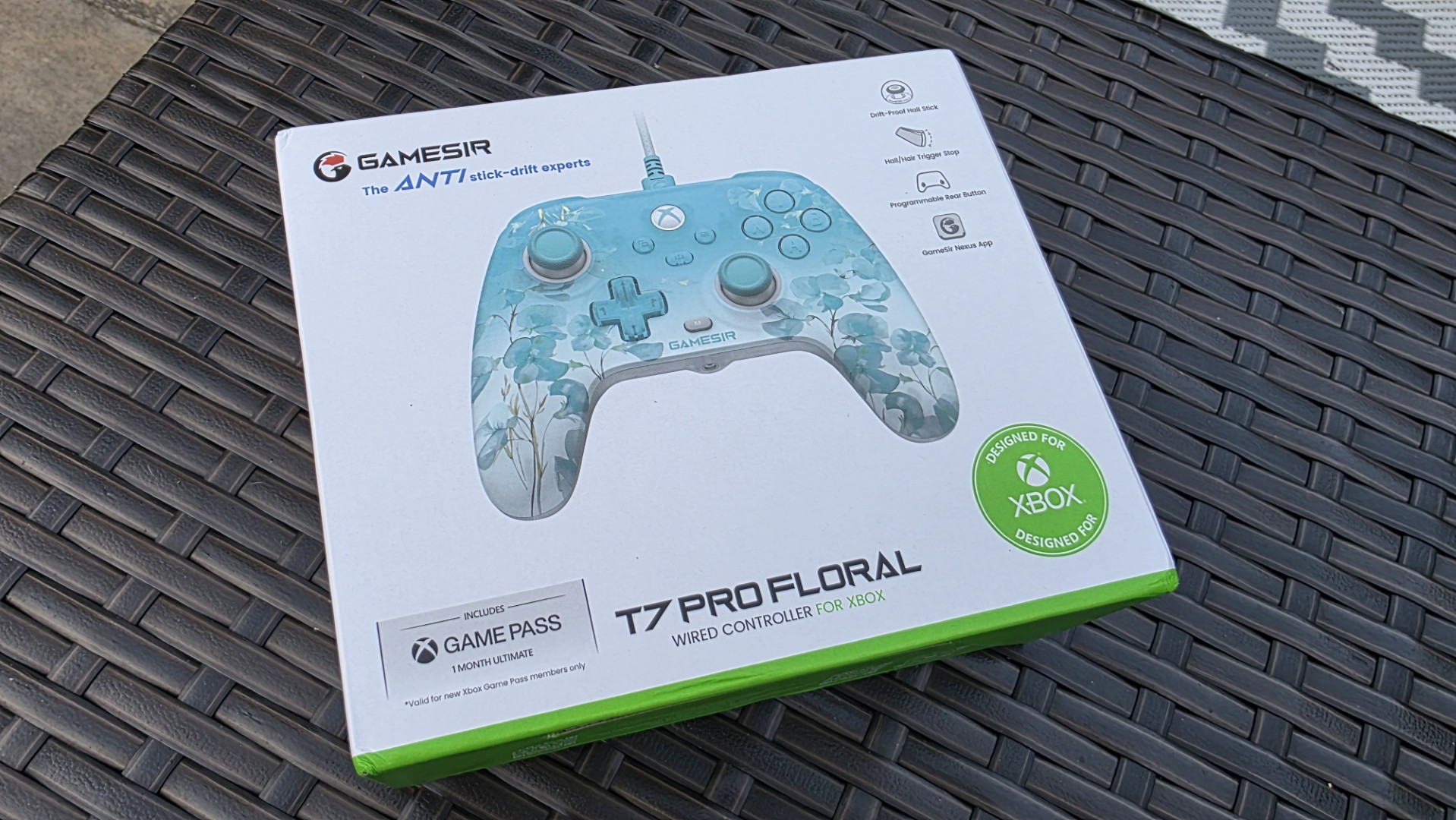 A blue and white controller with floral pattern