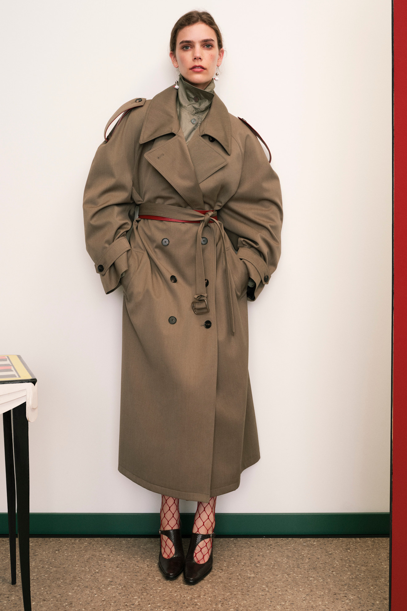 A model wore a thick trench coat in the Tory Burch Resort 2026 line