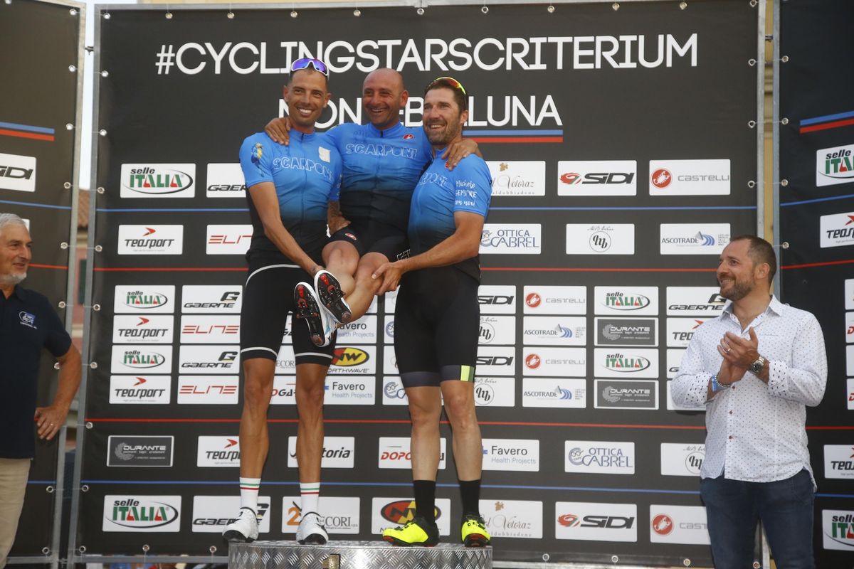 Alessandro Ballan and Matteo Tosatto give Paolo Bettini a little extra height