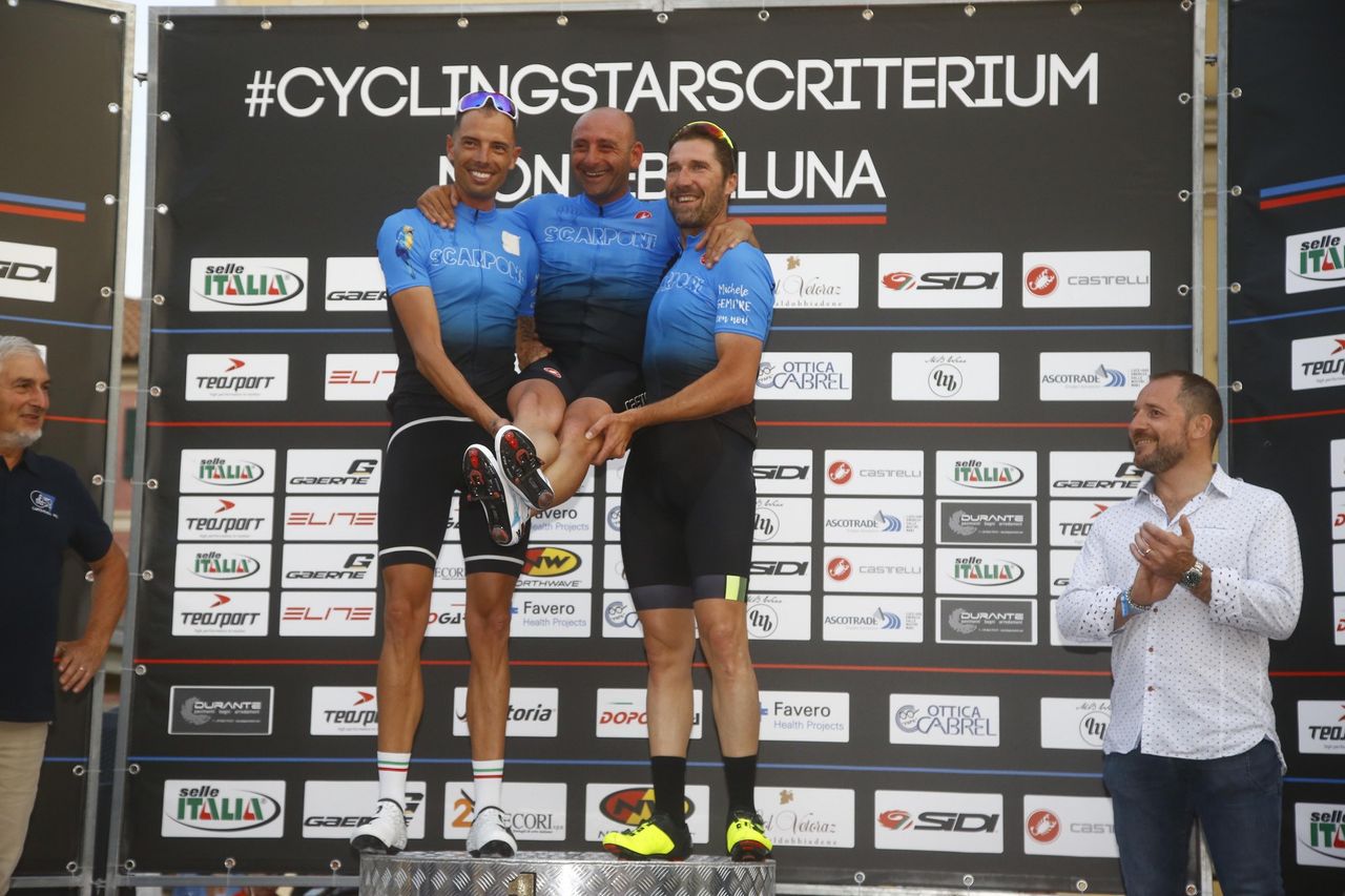 Alessandro Ballan and Matteo Tosatto give Paolo Bettini a little extra height