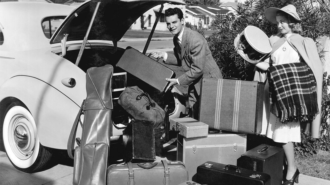 A 1930s couple packing to go on holiday