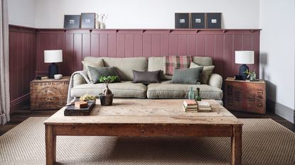 sitting room with pink tongue and groove, neutral sofa and wooden coffee table