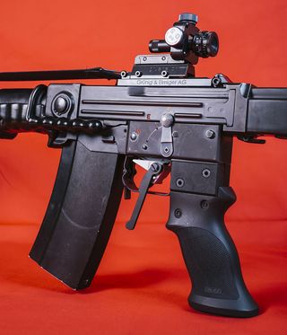 A black gun against a red background