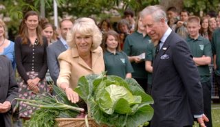LONDON - JULY 17: Prince Charles, Prince of Wales and Camilla, Duchess of Cornwall are presented with vegetables from the allotment as they visit the 'Dig for Victory' organic allotment in St James' Park on July 17, 2008 in London, England. The Duchess of Cornwall was celebrating her 61st Birthday. (Photo by Samir Hussein/WireImage)