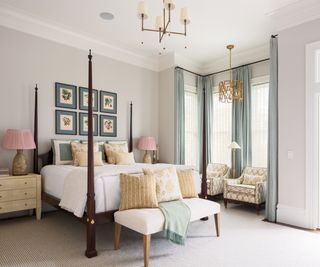 four posted bed in a large neutral bedroom with pink and blue accents