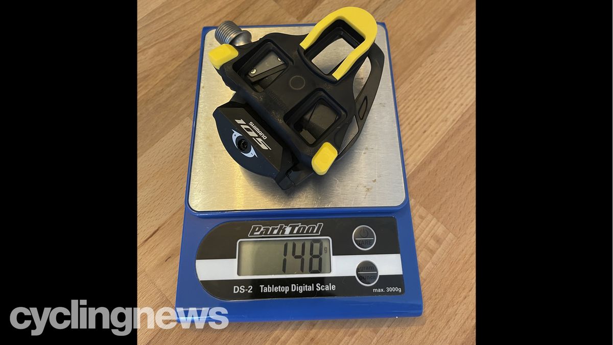 The Shimano 105 Pedals and cleat on a Park Tools scale, showing a combined weight of 148g