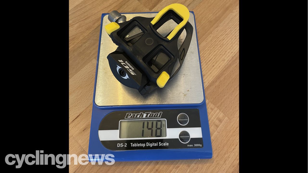 The Shimano 105 Pedals and cleat on a Park Tools scale, showing a combined weight of 148g