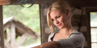 Elizabeth Halsey (Cameron Diaz) stands in a garage and reaches an arm out in 'Bad Teacher'