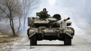 Ukrainian servicemen ride on tanks towards the front line to engage with Russian forces in the Lugansk region of Ukraine, on Feb. 25.
