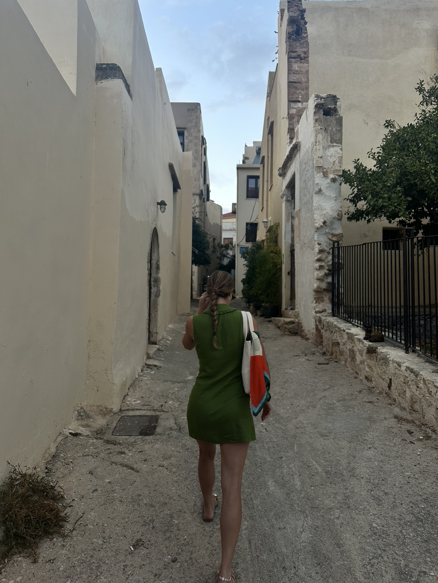 the author walking in Chania, the bow of a boat in an inlet on the sea, an archeological site