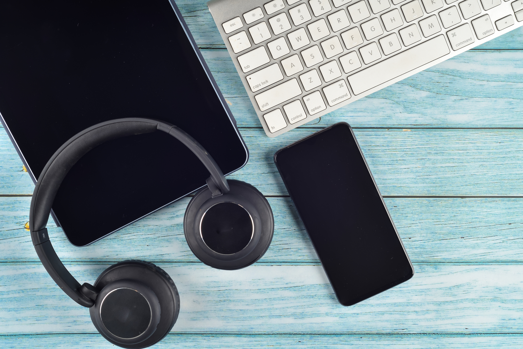 Directly above shot of bluetooth headphones with mic for mobile phones, tablets, laptops with copy area