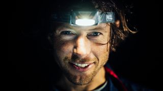 Hiker wearing Petzl Tikkina headlamp