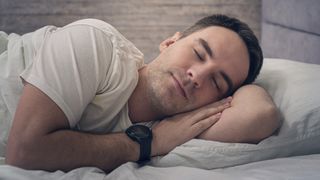 Sleeping man wearing sports watch