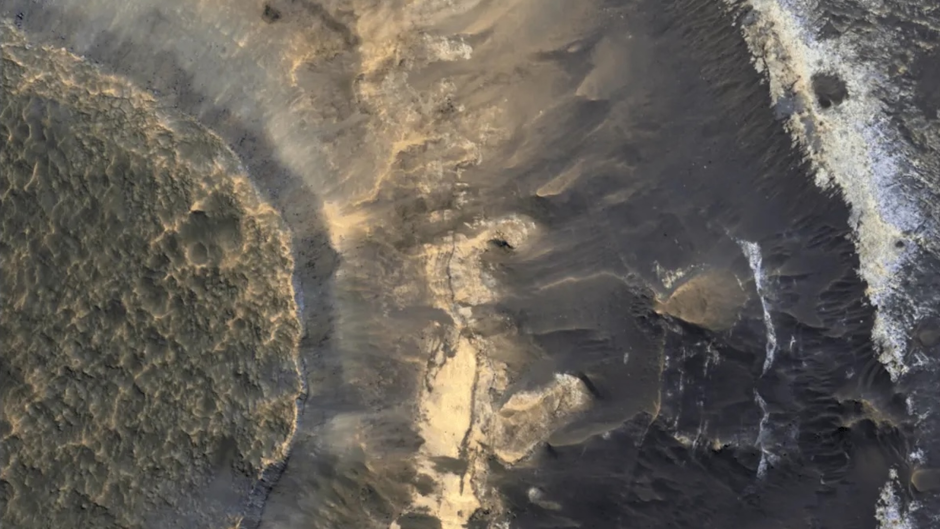 A photo of Mars landscape, with brown cracks and rock formations