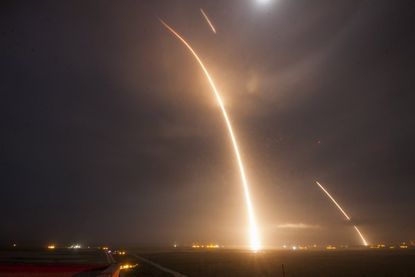A long exposure of the launch and re-landing burns of the Falcon 9 rocket.
