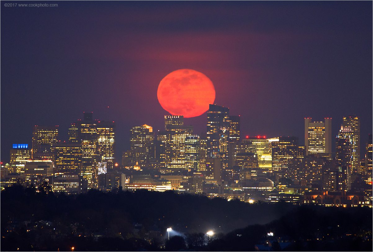 The full pink moon rises over Boston in this photo taken by Chris Cook on Wednesday (April 11). April's full moon isn't actually pink; it's named after the wild ground phlox, one of the first flowers to bloom in spring. Cook said the full moon appeared red-orange that evening due to the thick atmosphere, dust, haze and pollen in the air.