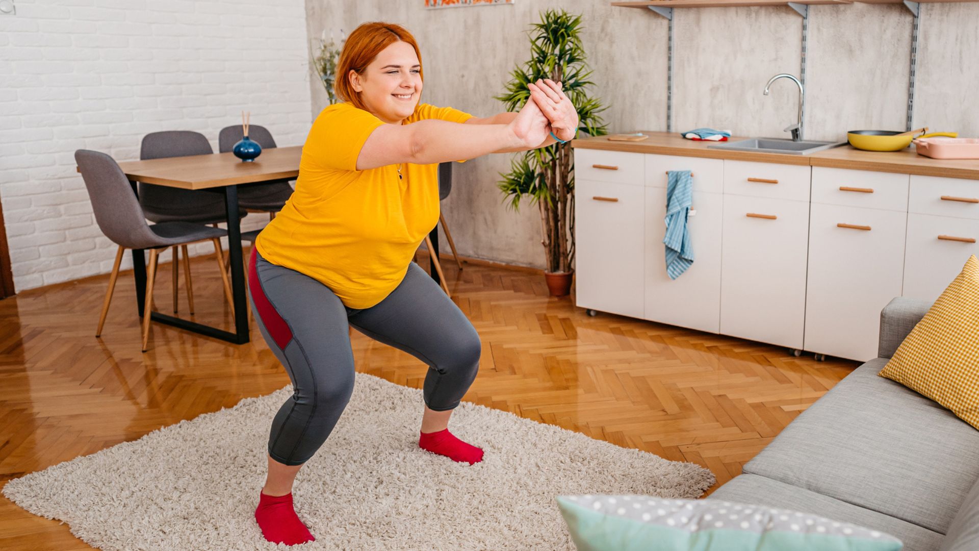 woman does squat exercise at home 