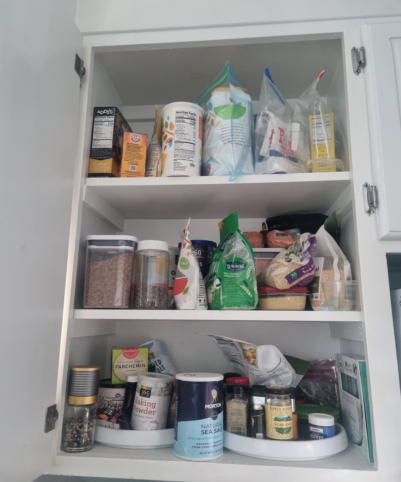 A cluttered kitchen cabinet